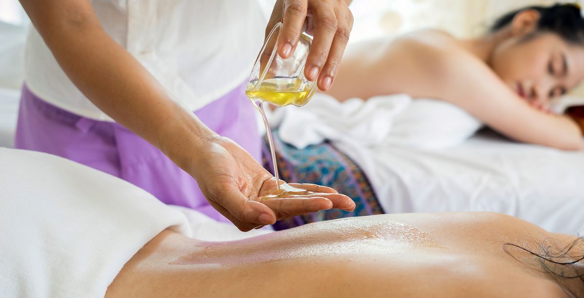Two women enjoying oil massage treatment